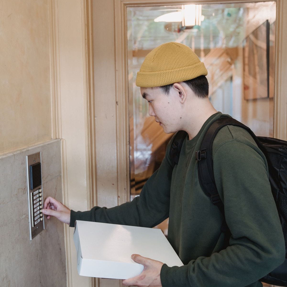 Courier at an apartment door delivering a home oxygen order